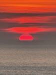 Soleil rouge au-dessus de la mer